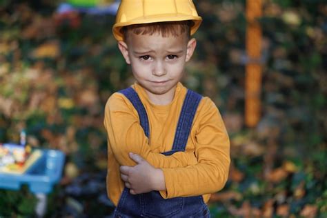 Premium Photo | Portrait of kid boy builder wearing protective yellow ...