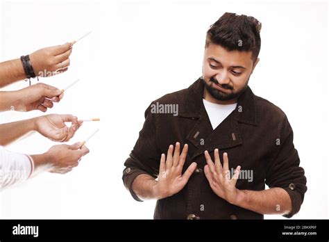 No Smoking. Young Man Wearing A Brown Coat Refusing Cigarette Isolated On White Stock Photo - Alamy