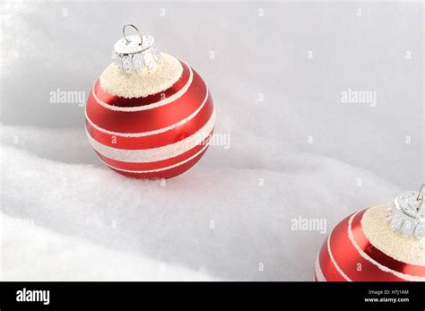 Christmas Baubles on snow white background Stock Photo - Alamy