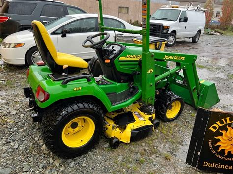 JOHN DEERE X595 4X4 TRACTOR WITH MOWER AND FRONT END LOADER ATTACHMENTS, DEAD BATTERY, HOURS