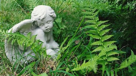 Premium Photo | Angel statue in grass