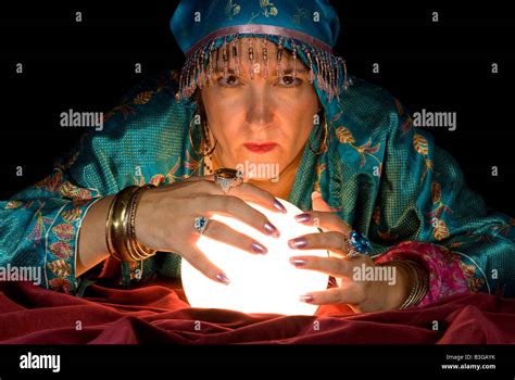 A gypsy fortune teller brings her crystal ball to life to read the ...