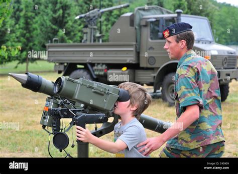 Soldier showing Mistral Air Defence Missile System to child during open day of the Belgian army ...