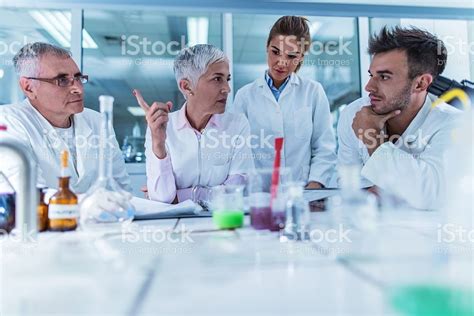 Team of chemists having a meeting in laboratory and discussing about... | Equality in the ...