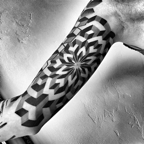 a black and white photo of a person's arm with a tattoo on it