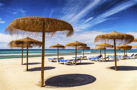 Spain, Menorca, Son Bou, beach with sunshades stock photo