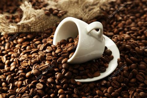 Cup with coffee beans, close up Stock Photo by ©belchonock 21922437