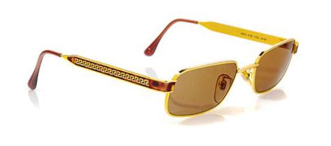 * A Pair Of Versace Gold Frame Sunglasses,