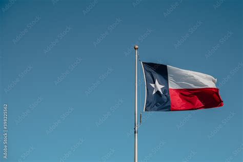 Texas state flag on blue sky Stock Photo | Adobe Stock