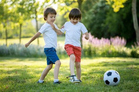 Two Cute Little Kids, Playing Football Together, Summertime. Chi Stock ...