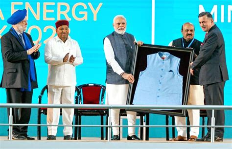 Prime Minister Narendra Modi being presented a jacket