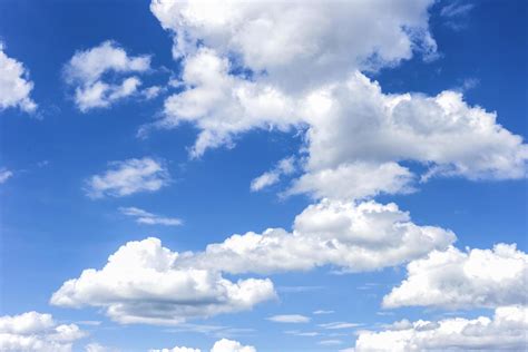 clear blue sky with plain white cloud with space for text background. The vast blue sky and ...