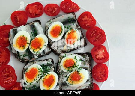 A traditional Estonian sprat sandwich (kiluvõileib) - Baltic sprat fish and boiled egg slice ...