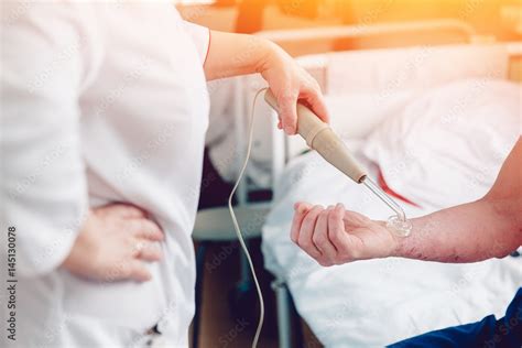 doctor with the phone treats a patient with a skin disease using the ...