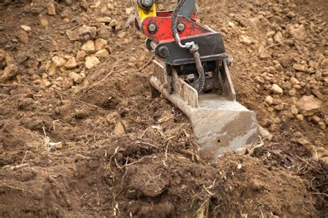 Premium Photo | Earth mover digging dirt at construction site