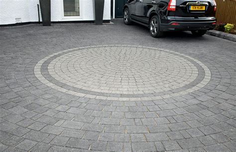 Modern grey paved driveway with a circle pattern in the middle which is a lighter grey. # ...