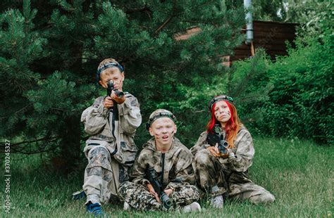 Children playing in lasertag shooting game, boy with a gun, war ...