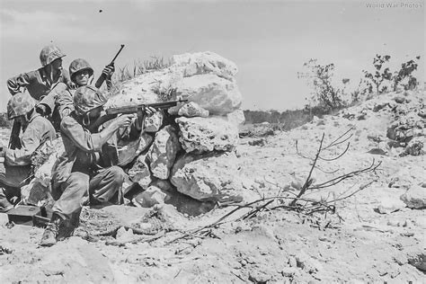 Leathernecks of the 1st Marine Division fighting from the cover of a coral knob during the ...