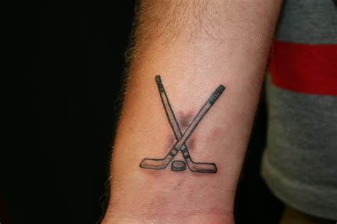 This hockey player couldn't wait to get this stick & puck tattoo. Done by Cody Mennis of ...