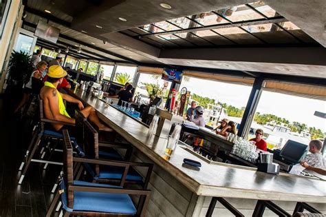 Grab a drink or stop by for Happy Hour at Lighthouse Grills beautiful bar overlooking the Yacht ...