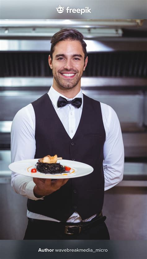 Premium Photo | Handsome waiter holding a plate of squid ink spaghetti | Waiter, Chef images ...