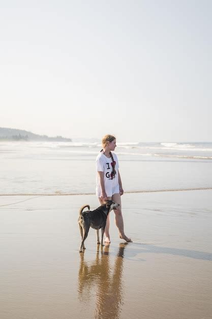 Premium Photo | A person with a dog on a beach