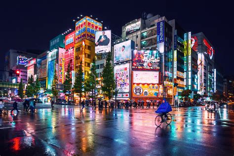 Neon lights and billboard advertisements on buildings at Akihabara at rainy night, Tokyo, Japan ...