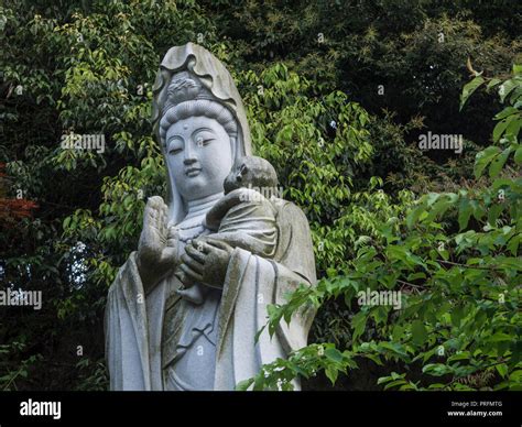 Kannon Bosatsu statue with child, Senyuji temple 58, Shikoku 88 temple pilgrimage, Ehime, Japan ...