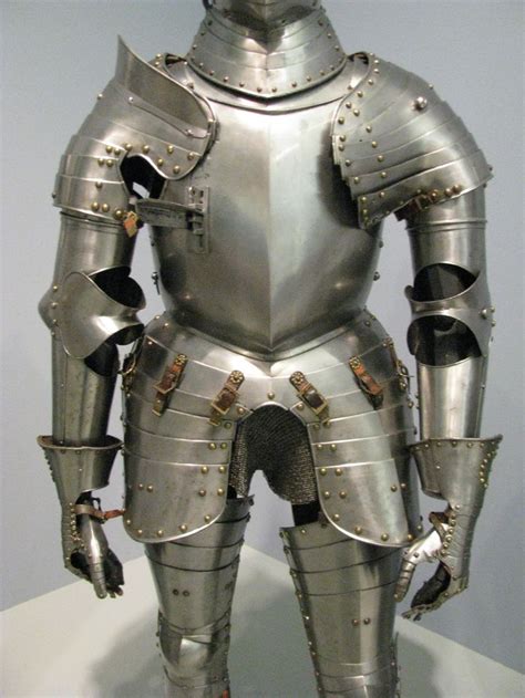 the armor is made from metal and has many rivets on its back legs