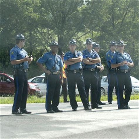 several police officers are standing on the side of the road with their arms crossed in front of ...