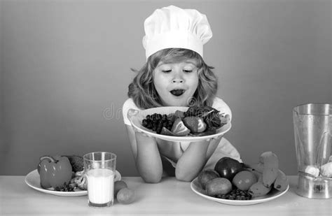 Excited Funny Chef Cook Hold Plate with Fruits. Kid Boy in Chef Hat and Apron Cooking Preparing ...