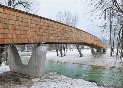 Architects create beautiful arched footbridge out of timber planks and shingles | Inhabitat ...