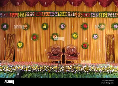 India wedding reception stage with two chairs and flower decorations Stock Photo - Alamy