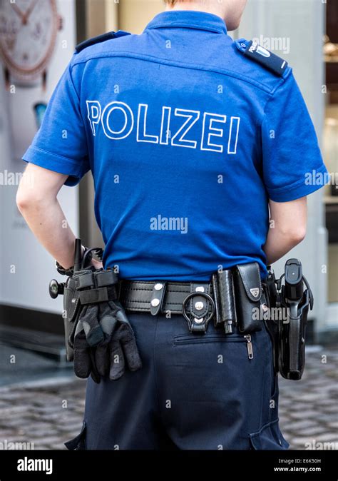 Female Swiss police officer in uniform with equipment, from behind, Lucerne, Switzerland Stock ...