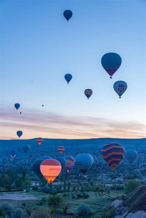 Balloons Flying at Sunset · Free Stock Photo