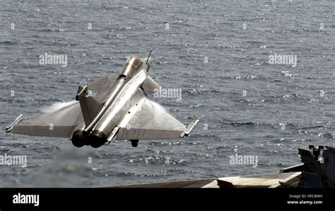 A French Rafale aircraft from the nuclear-powered aircraft carrier French navy ship Charles de ...