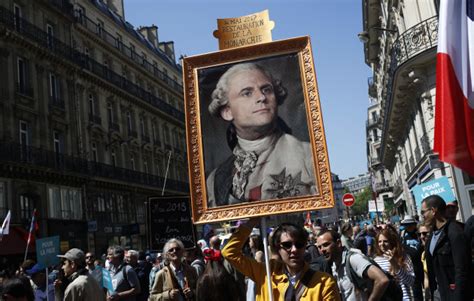 Thousands throng streets of Paris in protest against President Emmanuel Macron