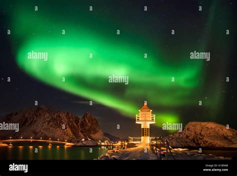 Aurora borealis above lighthouse and snowy islands of Lofoten Stock ...