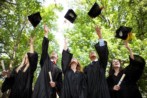 "Graduation: New Graduates Toss Caps Into The Air" by Stocksy Contributor "Sean Locke" - Stocksy