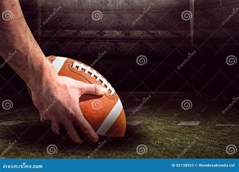 Composite Image of American Football Player Preparing for a Drop Kick ...