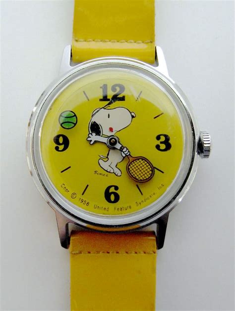 a yellow watch with a cartoon dog holding a tennis racquet