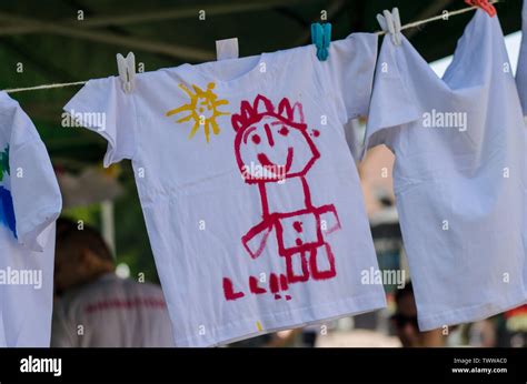 white T-shirt painting with colors Stock Photo - Alamy