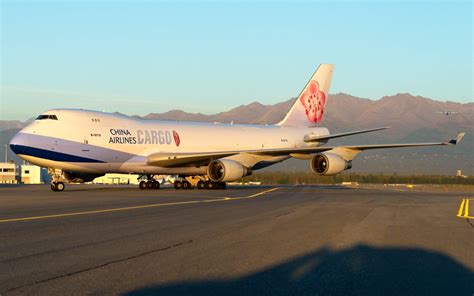 China Airlines Boeing 747F hits baggage pallets, suffers engine damage ...