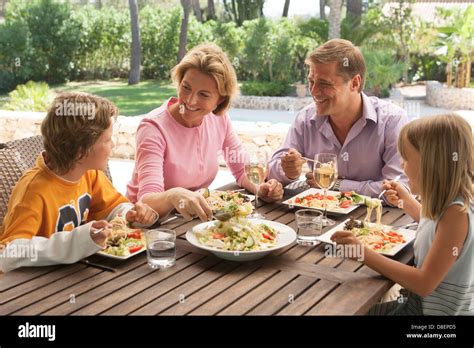 Family eating together alfresco Stock Photo - Alamy