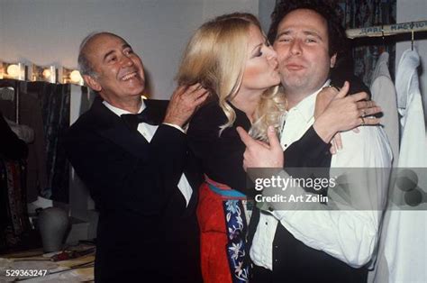 Rob Reiner being kissed on the cheek by Sally Struthers in their ...