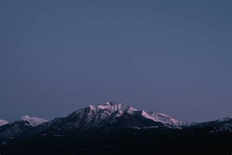 A view of a mountain range with snow on it photo – Free Snow Image on ...