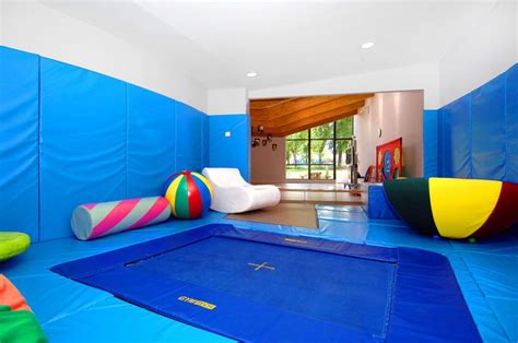 an indoor play area with blue walls and colorful balls