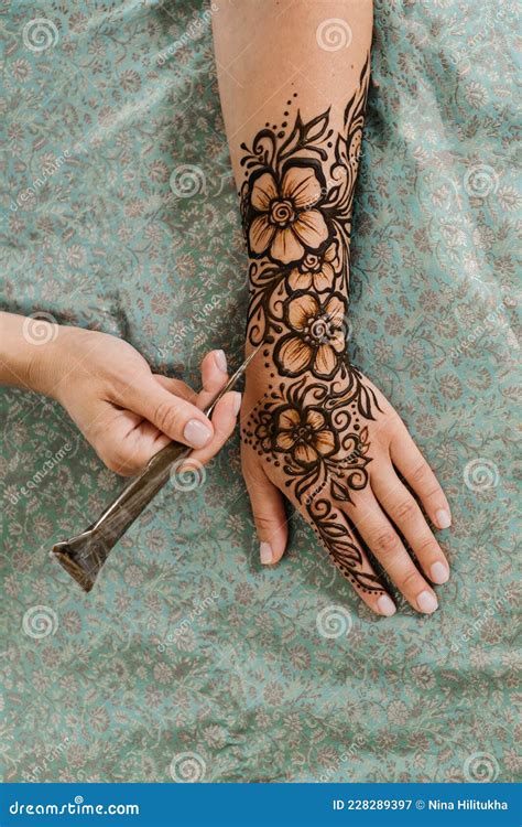 Artist Applying Floral Henna Tattoo on Women Hands, Design for Beauty Stock Image - Image of ...