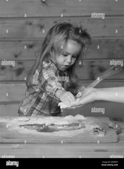 Baby child cooking, playing with flour at wooden kitchen Stock Photo - Alamy