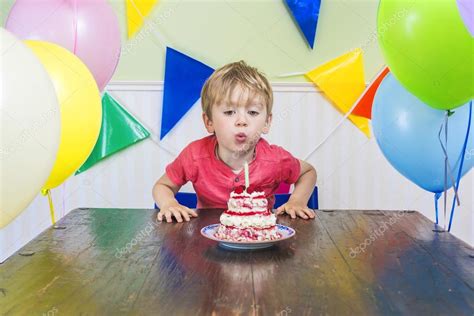 Boy blowing out a birthday candle — Stock Photo © red_pepper82 #81084010